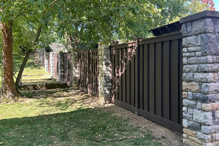 Trex composite privacy fence with stone columns Lexington KY