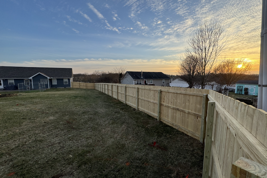 Wood privacy fence installation at golden hour Lexington Kentucky